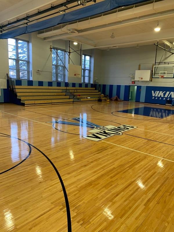 I.S. 7 gymnasium with refinished hardwood floor, Vikings center logo and wood bleachers
